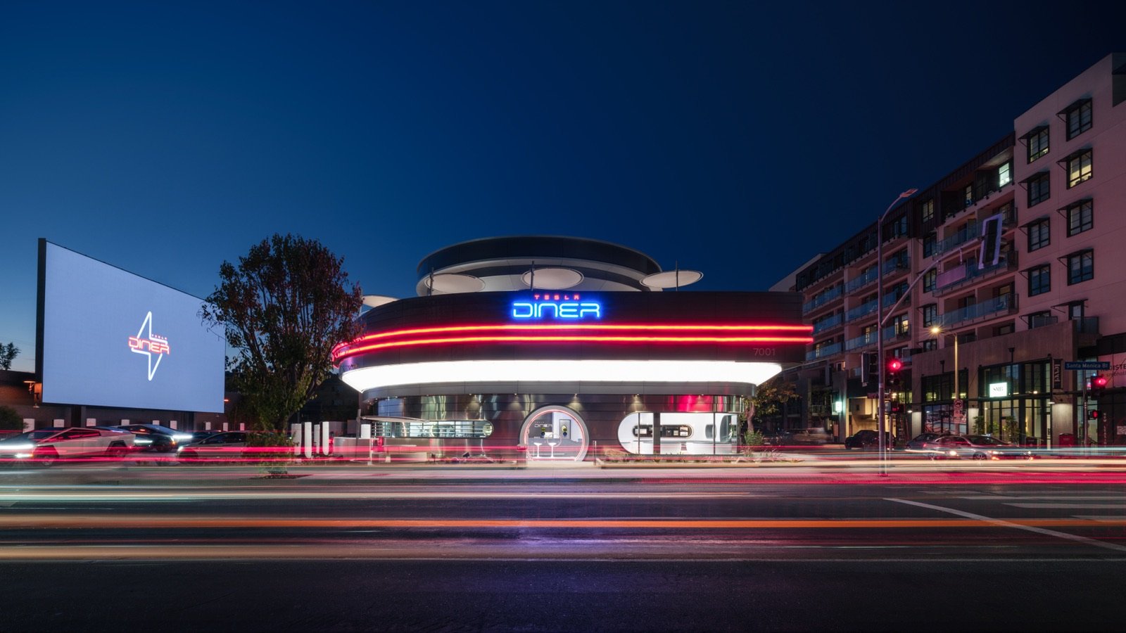 Tesla Diner flagship station in Hollywood, its neon sign lit up at night